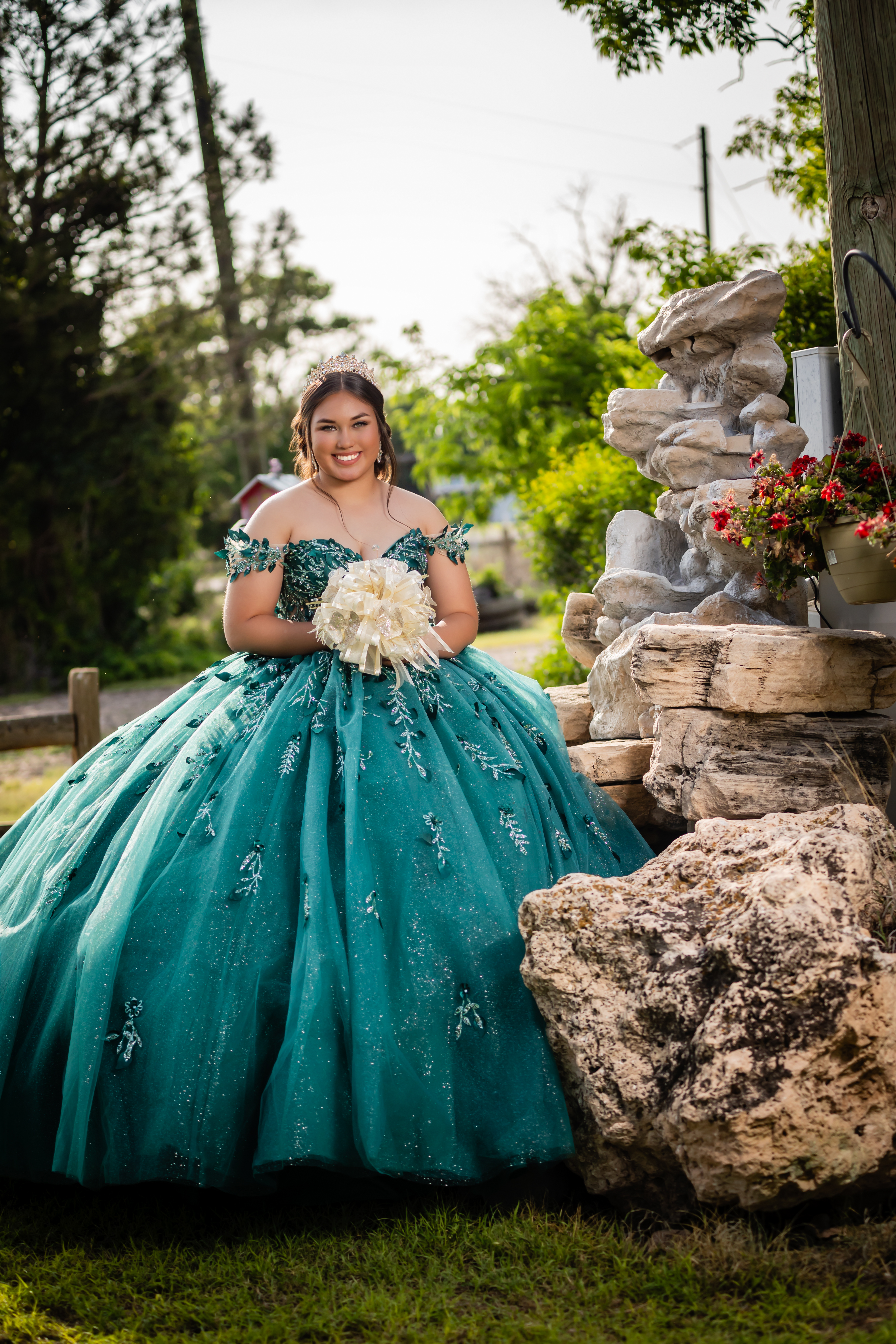 young lady standing next to a rock center piece in a beautiful birthday dress